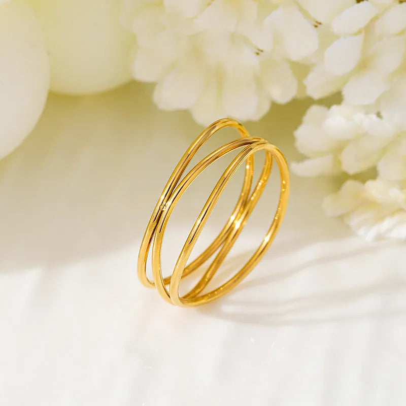 Gold geometric line ring with three-layer coil design in titanium steel