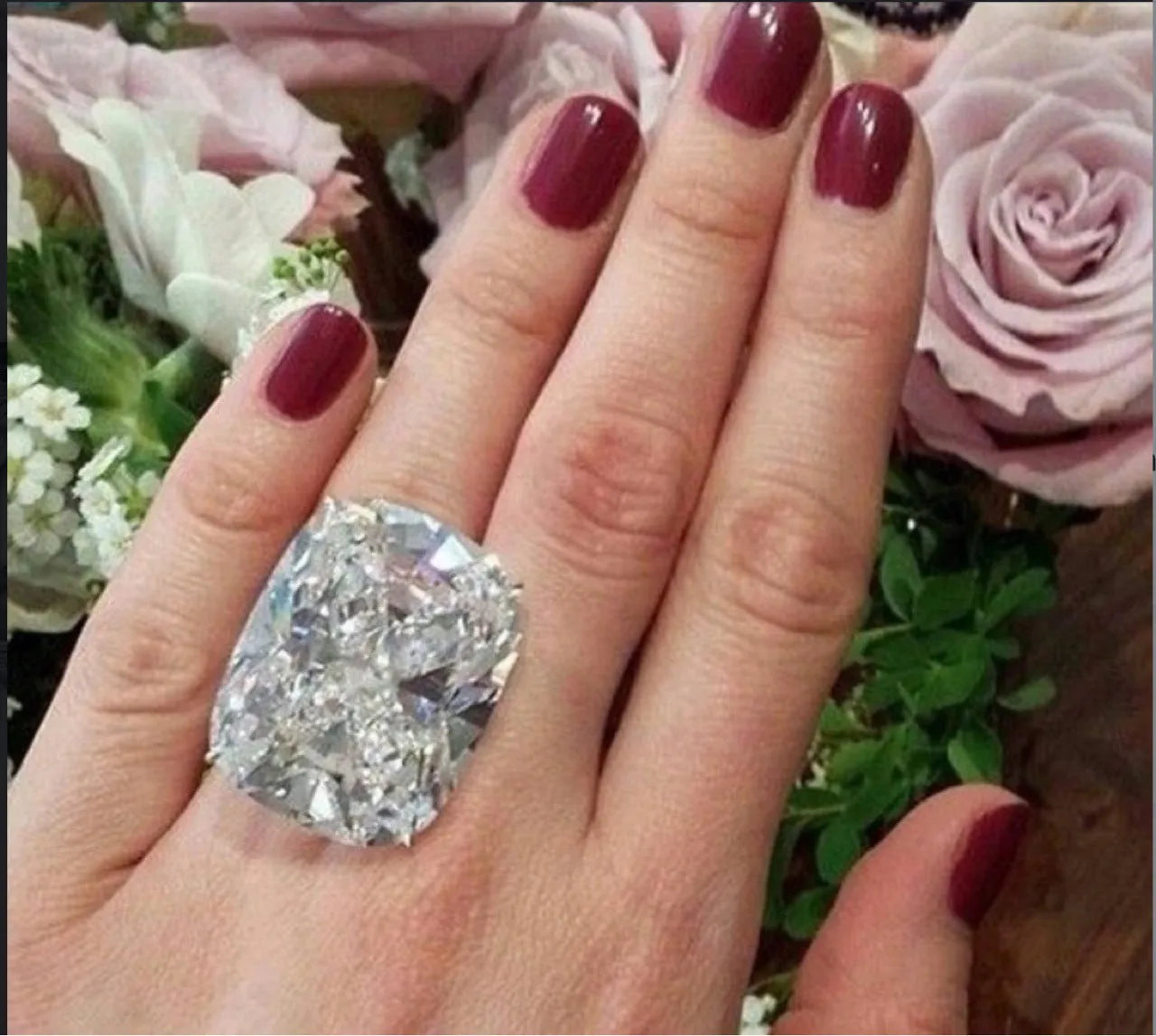 Simple women's ring with an inlaid square diamond design in a white gold colour.