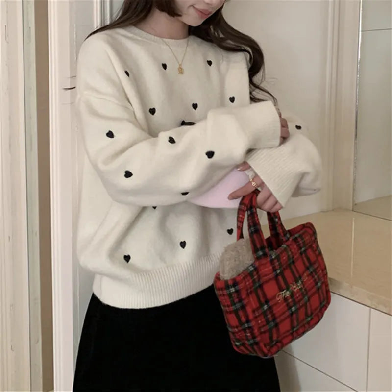 Women's loose-fit acrylic pullover sweater with embroidered love pattern in milky white.