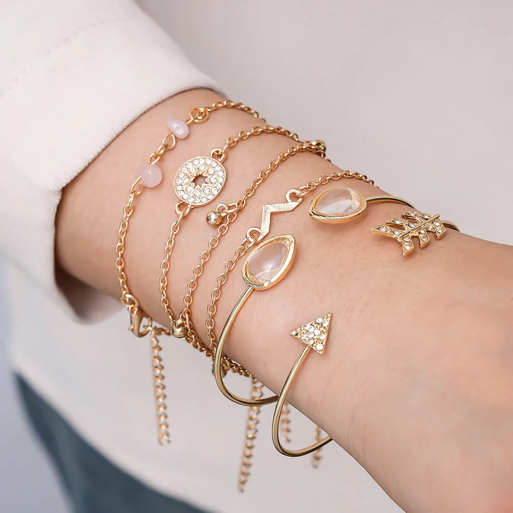 Women's gold colour bracelet set with 6 pieces showing water drop V-shaped pendants and drill arrow designs