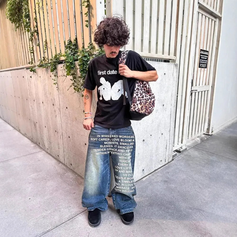 Men's loose wide-leg straight cotton trousers in black, front view, on model