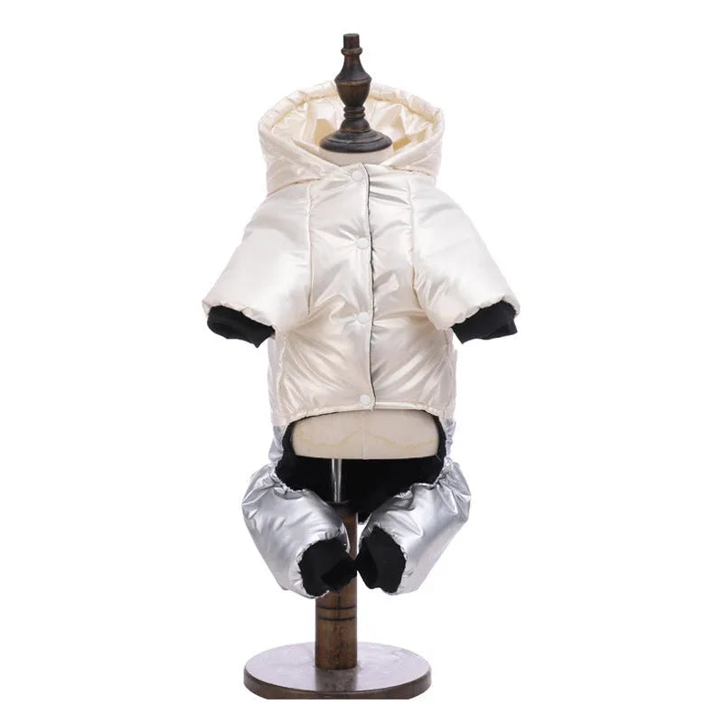 Green cotton dog coat with four-legged design and padded lining on a dog outdoors.