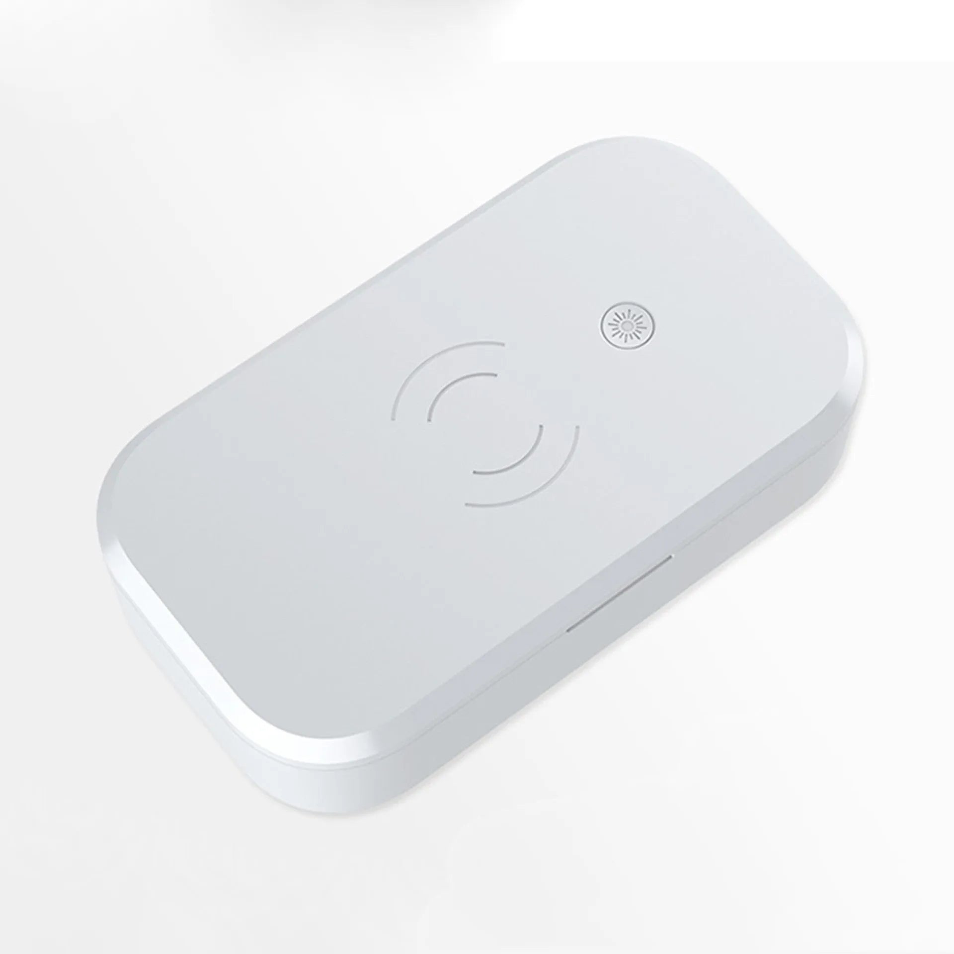 White ultraviolet disinfection box with wireless charging pad for mobile phones and nail tools.