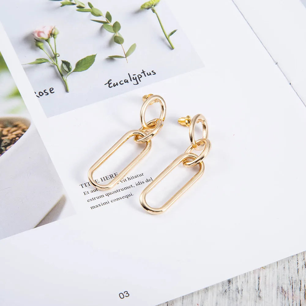 Geometric sterling silver needle coloured hoop earrings for women showing ring and line design elements.