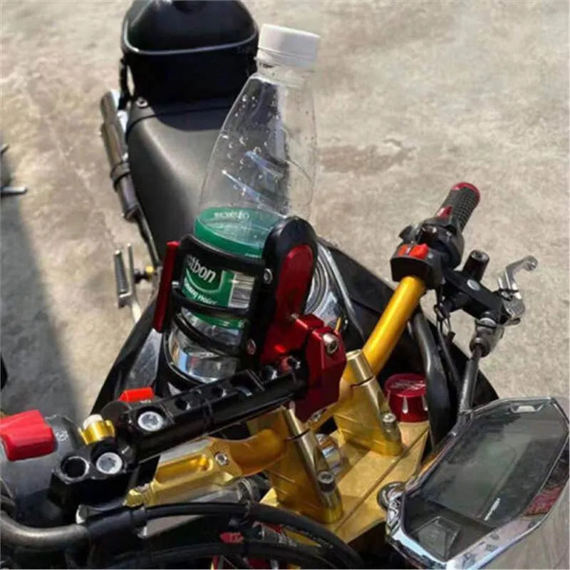 Modified black water bottle cage mounted on a Honda X-ADV scooter bumper.