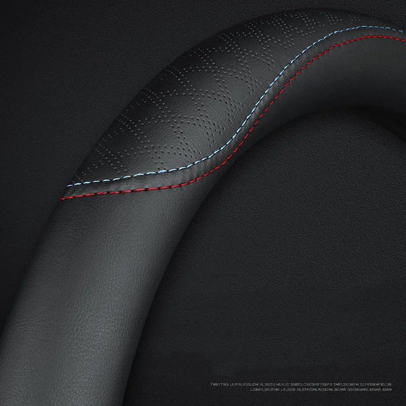 Black car steering wheel cover with two-colour line detail showing Napa leather texture and rubber inner ring