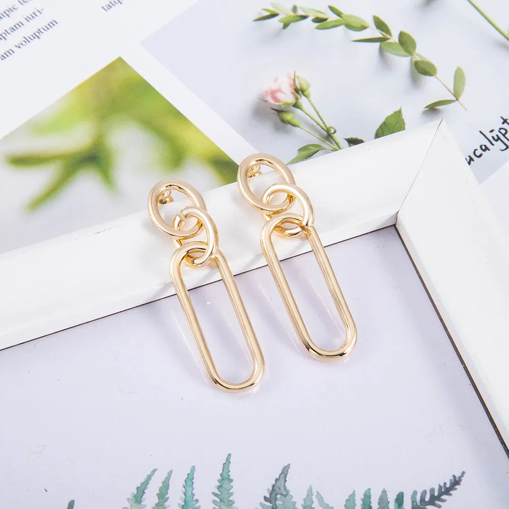 Geometric sterling silver needle coloured hoop earrings for women showing ring and line design elements.