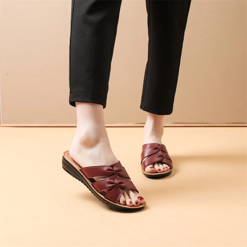 Women's cowhide leather soft bottom non-slip slippers in beige, black, and red colours on a light background