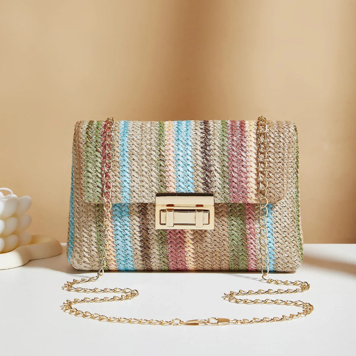 Women's straw cross-body bag in horizontal square shape, rainbow colour, with lock closure and single shoulder strap