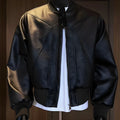 Men's black slim-fit PU leather jacket with extended 100cm length shown on model