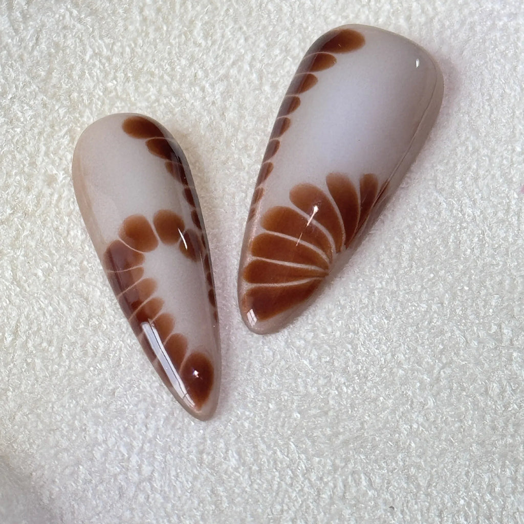 Leopard print false nails with cross and flower designs, shown in long wear armour style