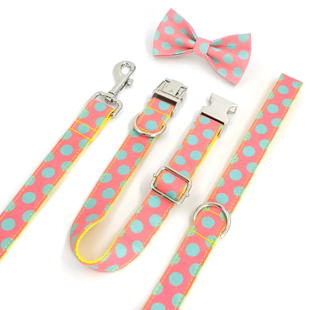 Yellow polka dot dog collar with bow and matching hand-held traction rope on white background