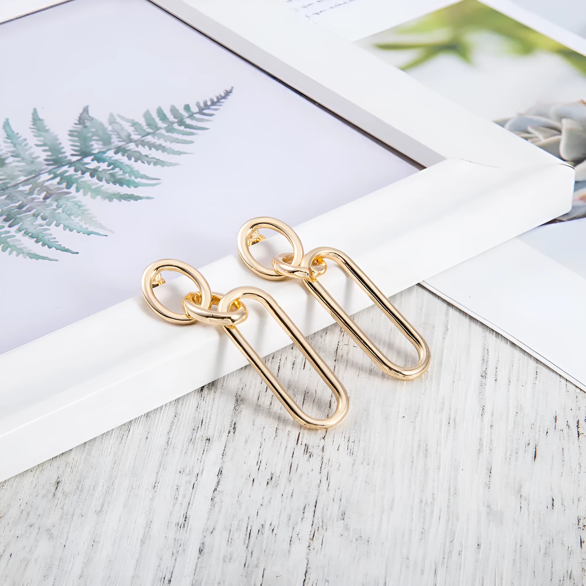 Geometric sterling silver needle coloured hoop earrings for women showing ring and line design elements.