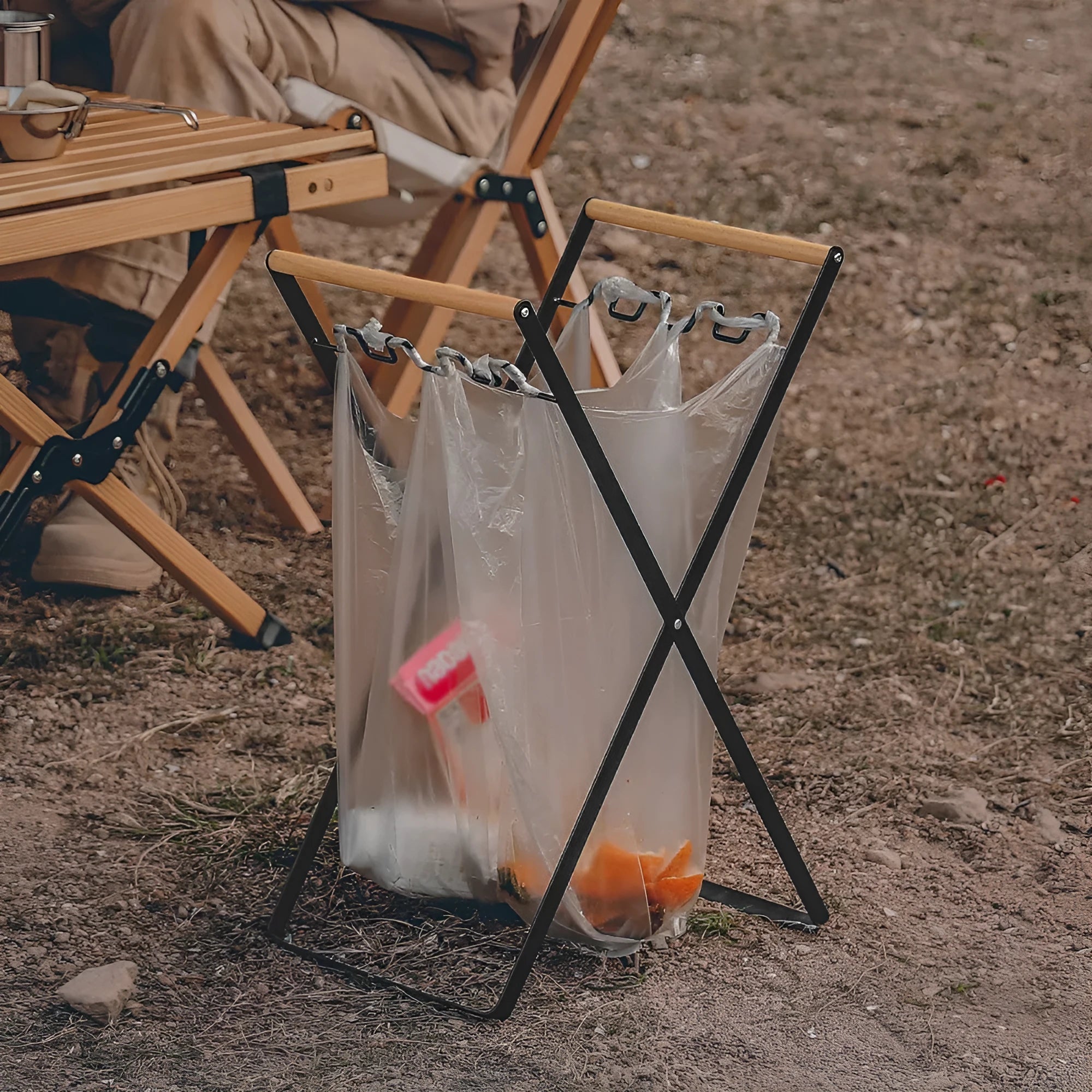 Outdoor folding garbage storage hanger with wrought iron frame and wooden handle.