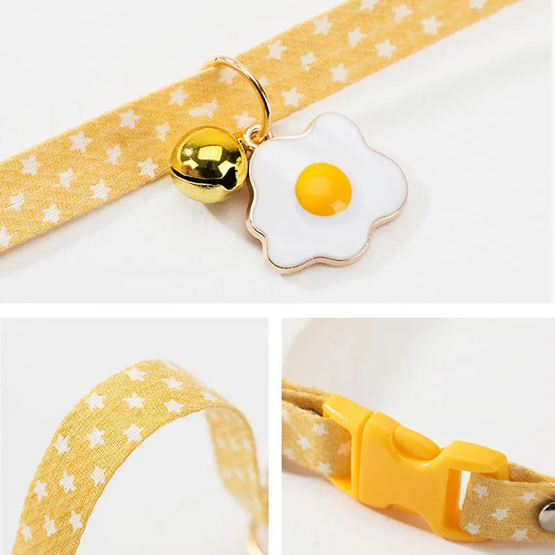 Green adjustable cat collar with a metal bell and red bow tie on a white background.