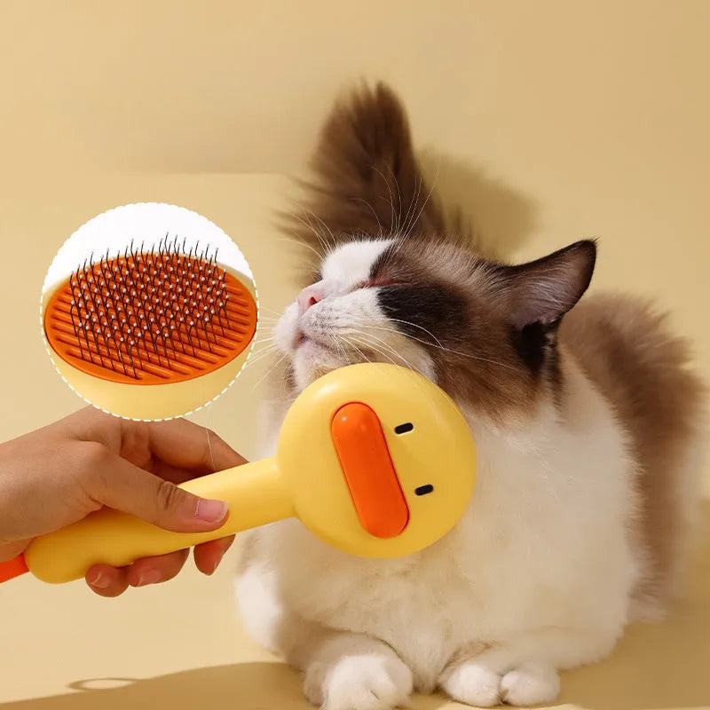 Small yellow duck-shaped pet comb for cat and dog grooming with needle teeth