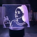 Slim European style acrylic 3D LED night light on a colourful black base, showing remote control.