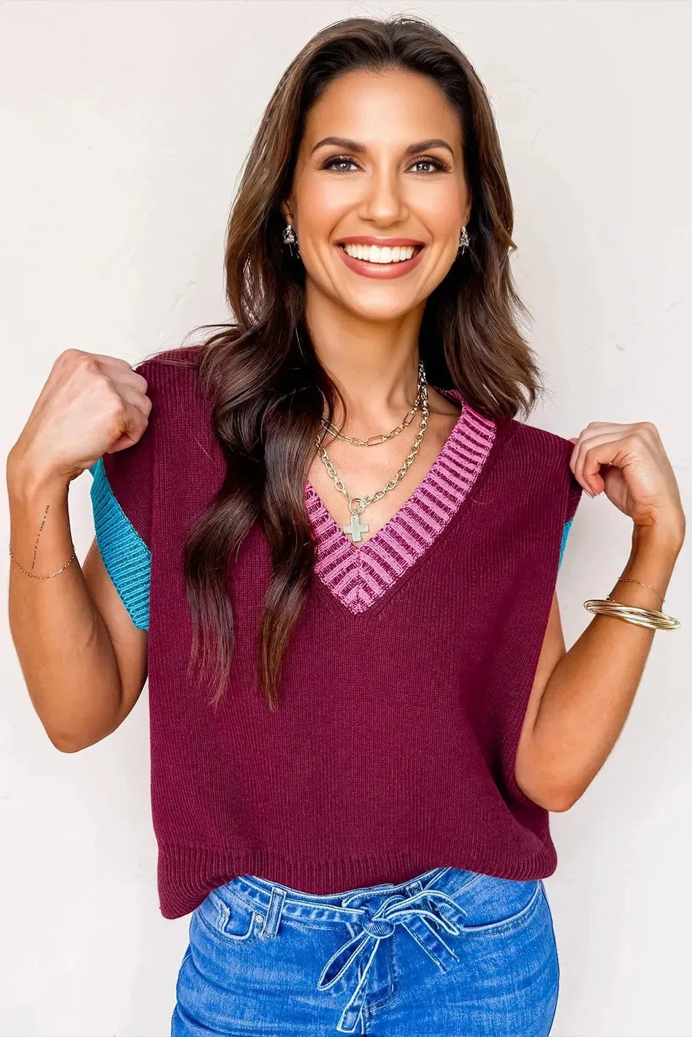 Burgundy loose-fitting women's V-neck sweater with light contrast trim on the neckline and cuffed short sleeves.