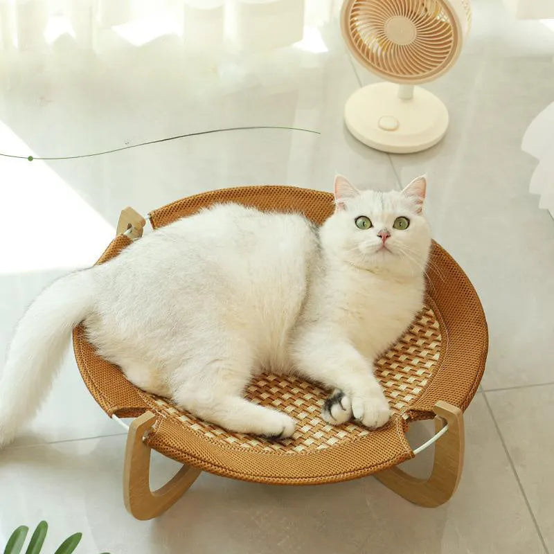 Brown woven rattan pet hammock bed for cats and dogs on a cool mat.