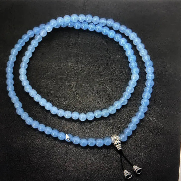 Alloy volcano white turquoise natural stone bracelet with adjustable cord on neutral background