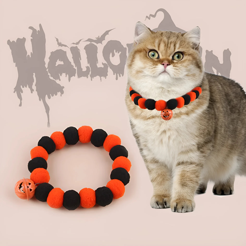 Orange Halloween pet collar for cats with pumpkin pattern and Trick or Treat text, showing plastic buckle.