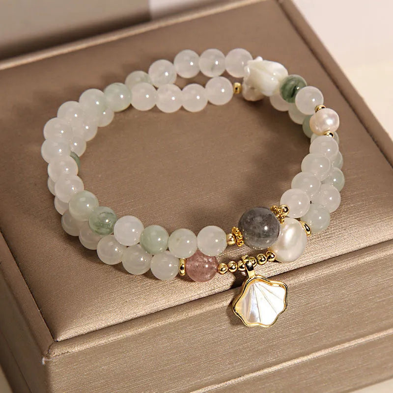Women's crystal bracelet with green ginkgo leaf pendant, gold accents and rhinestones