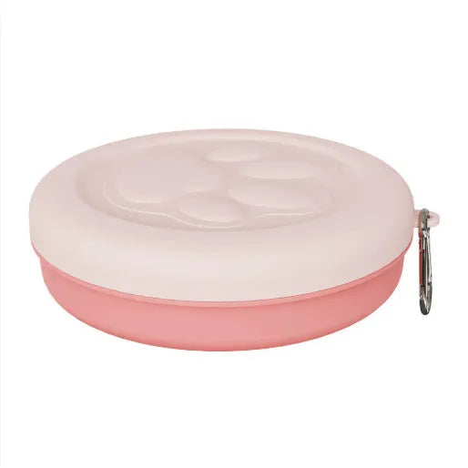 Portable dual-compartment dog bowl in light green, showing main bowl and separate snack box, suitable for outdoor use.