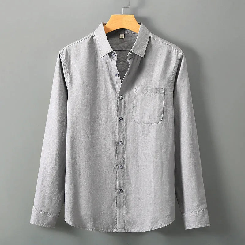 Man wearing a light sapphire blue, long sleeve linen cardigan in a Chinese style.