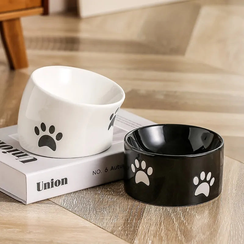 Ceramic cat bowl with oblique mouth and high foot, available in cat's paw colours pink, yellow, black, white