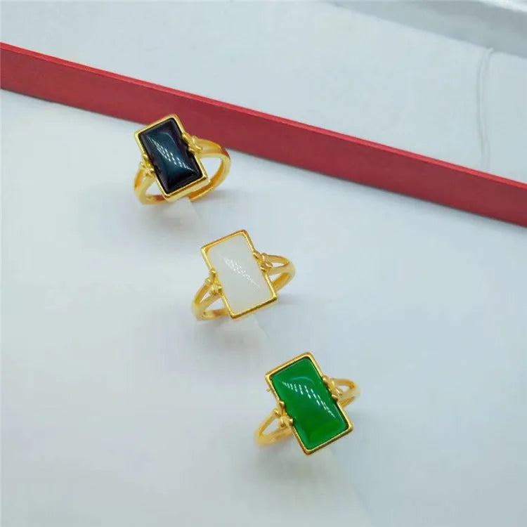 Adjustable brass gold-plated ring with electroplated gemstone inlay showing black, green and white colour options