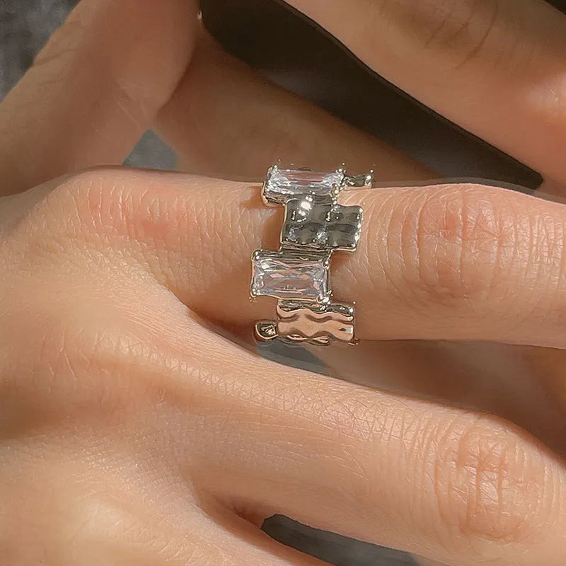Silver geometric cross ring with zircon detail and open retro design