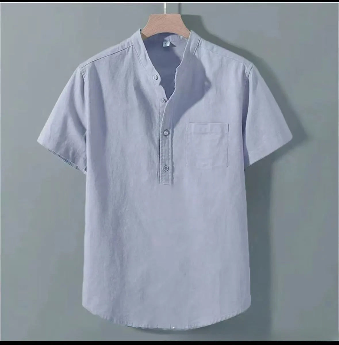 Man wearing a beige casual linen-blend shirt with a stand collar and short sleeves.