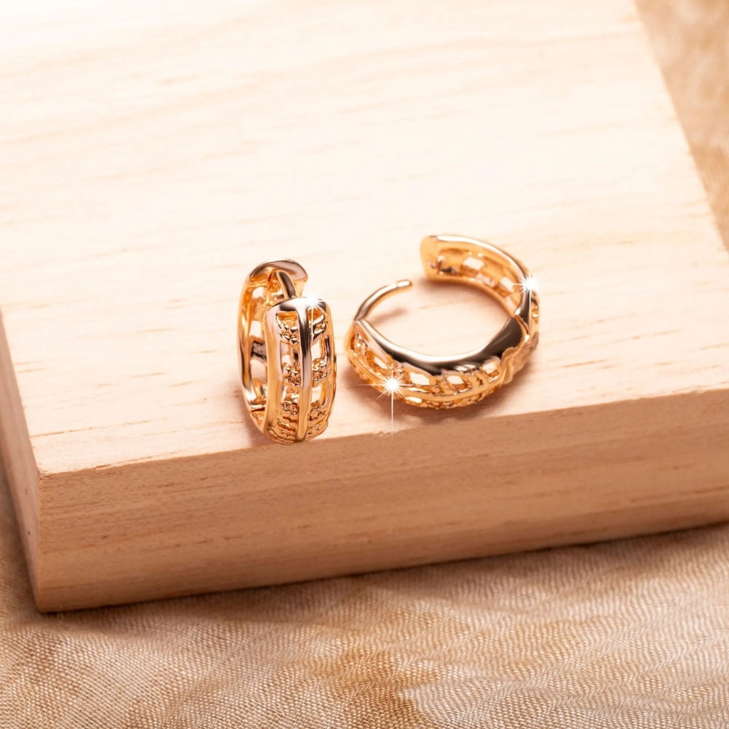 Rose gold plated copper earrings with hollowed-out leaf and heart shapes creating intricate cut-out patterns