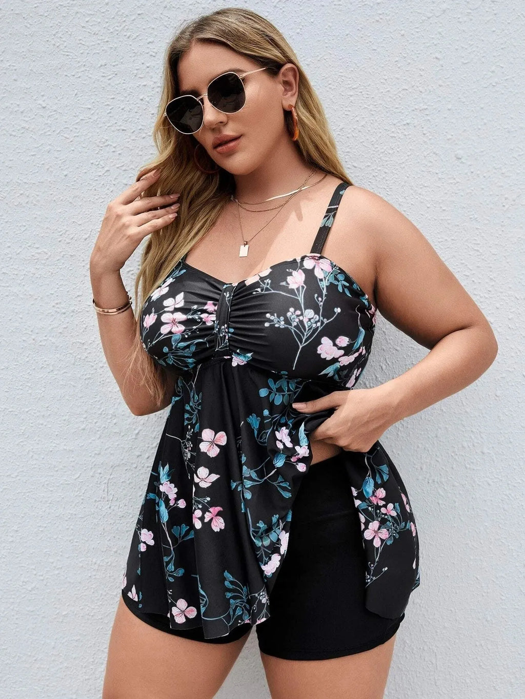 Women's floral print one-piece swimsuit on a hanger, showing split colour design.