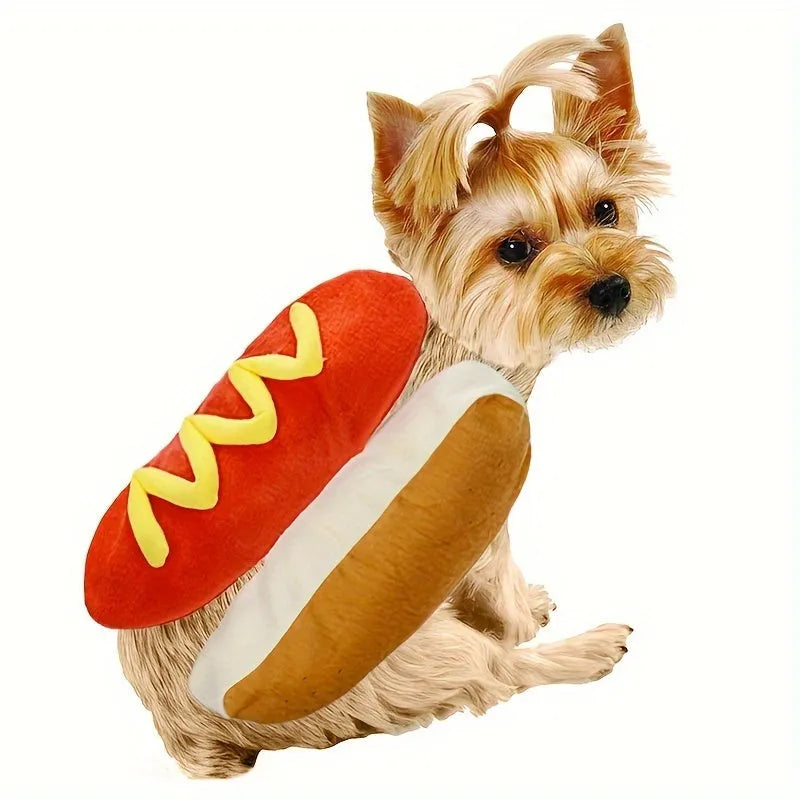 A small dog wearing a brown and beige plush hot dog costume with openings for head, legs, and tail.