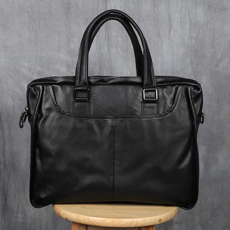 Black men's leather leisure briefcase with top layer cow hide, zipper closure, and shoulder strap