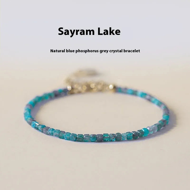 Natural blue apatite crystal bracelet with diamond-shaped beads, blue and grey colour, on a white background