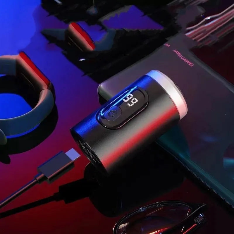 Black mini USB rechargeable shaver with LED display, shown with charging cable and cleaning brush.