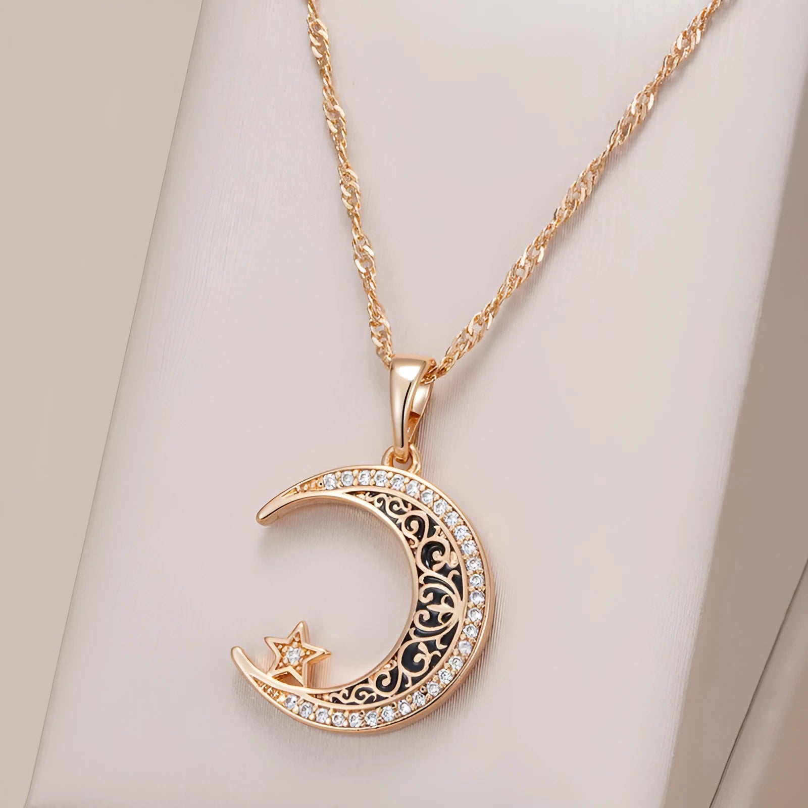 Rose gold star and moon necklace with zircon and enamel pendant on a water wave chain.