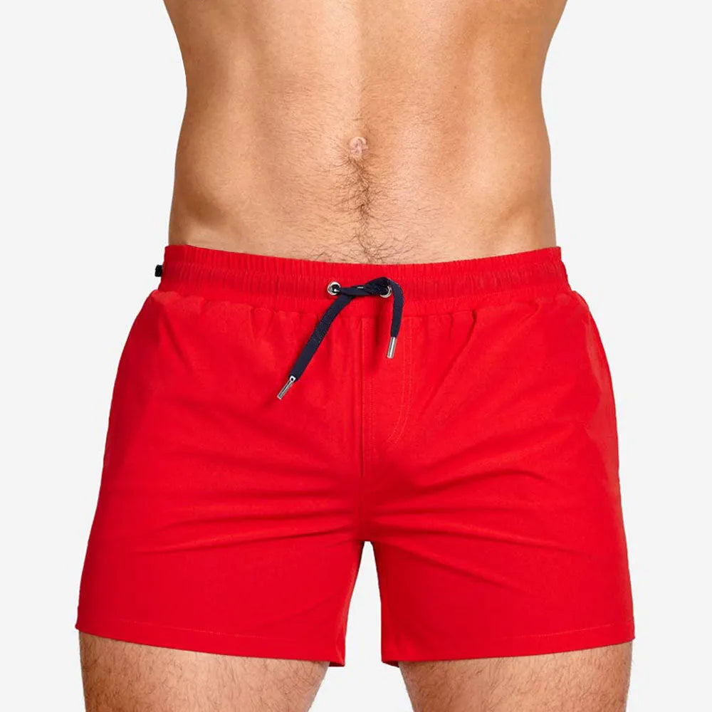 Polyester sports shorts with mesh lining in Army Green colour, laid flat.