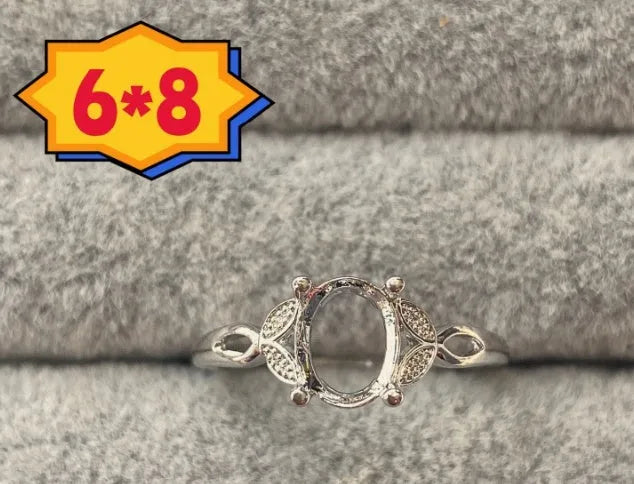 Oval denier copper ring with 6x8mm stone and star design on an open mouth band.