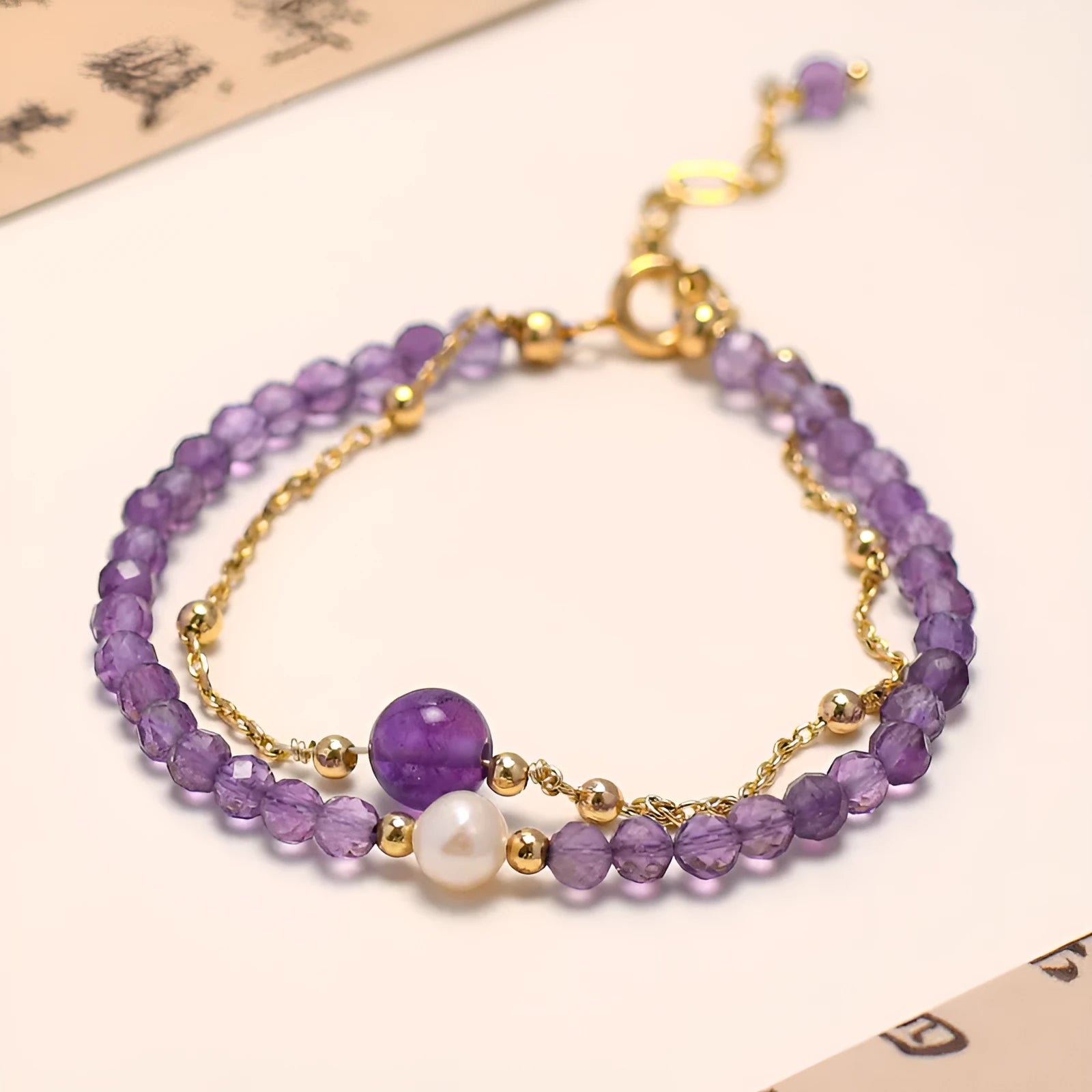 Chinese style women's bracelet with amethyst crystal stones in diamond cut on electroplated metal band