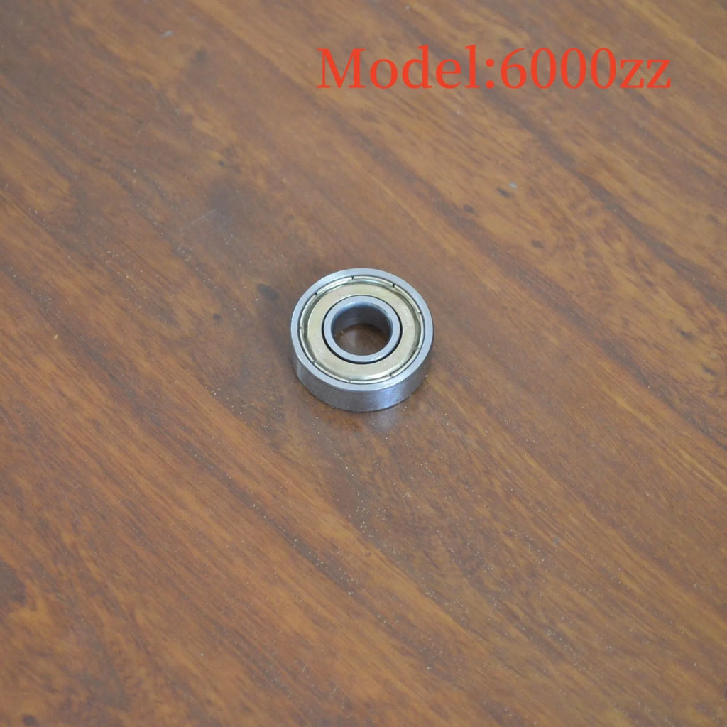 Carbon steel bearing 6000zz 10x26x8mm with iron retainer on white background