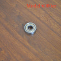 Carbon steel bearing 6000zz 10x26x8mm with iron retainer on white background
