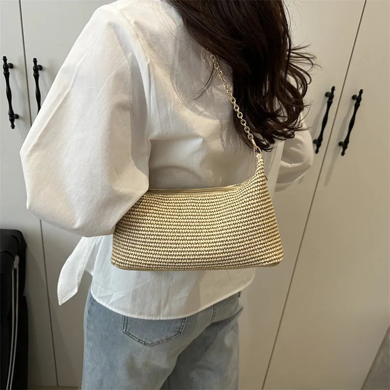 Vacation style straw woven beach shoulder tote bag in horizontal square shape with sandwich pocket