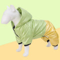 Green cotton dog coat with four-legged design and padded lining on a dog outdoors.