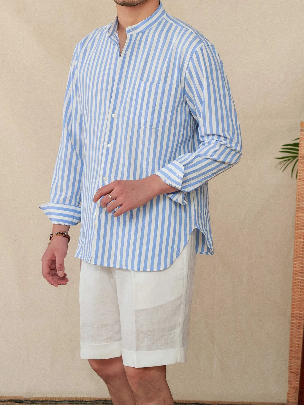 Loose fit seersucker striped long sleeve shirt with baseball collar in blue colour, front view on white background