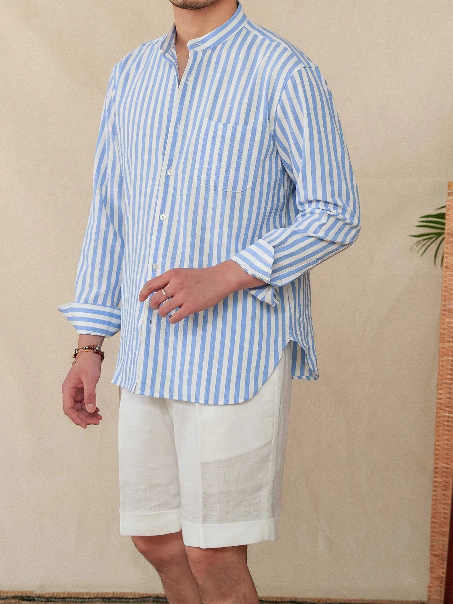 Loose fit seersucker striped long sleeve shirt with baseball collar in blue colour, front view on white background