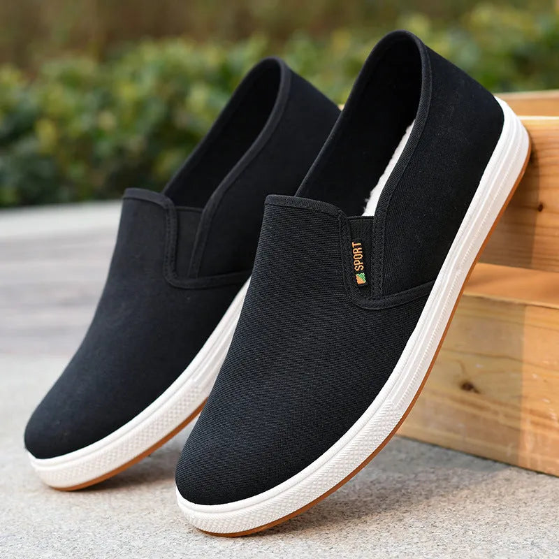 Men's black canvas slip-on shoes with round toe and injection-moulded sole