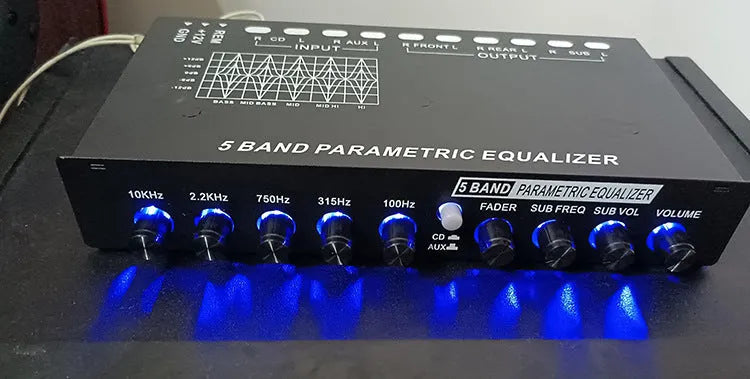 Black car audio EQ tuning amplifier with front panel controls for frequency and volume adjustment